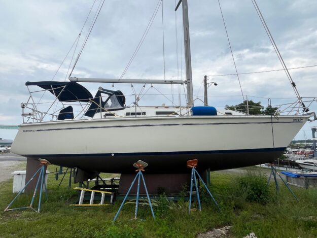1986 Pearson 33-2 sailboat on stands, ready for maintenance at a marina.