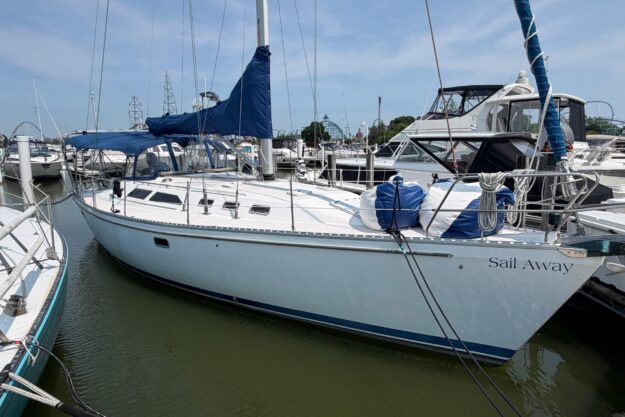 1995 Catalina 400 sailboat docked in marina, named “Sail Away,” with blue covers.
