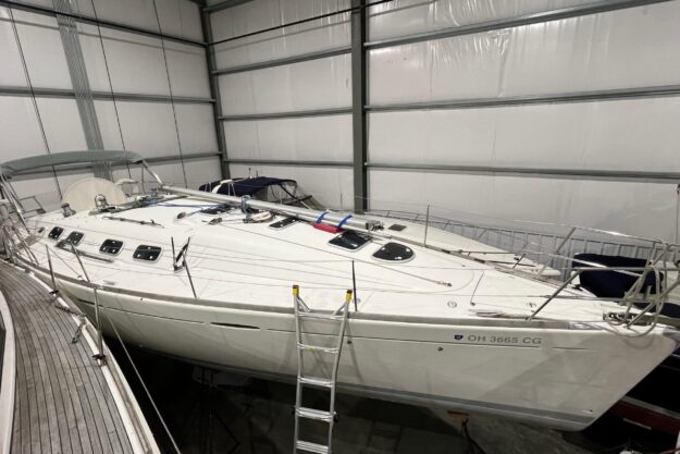 1999 Beneteau First 42s7 sailboat in indoor storage, side view.