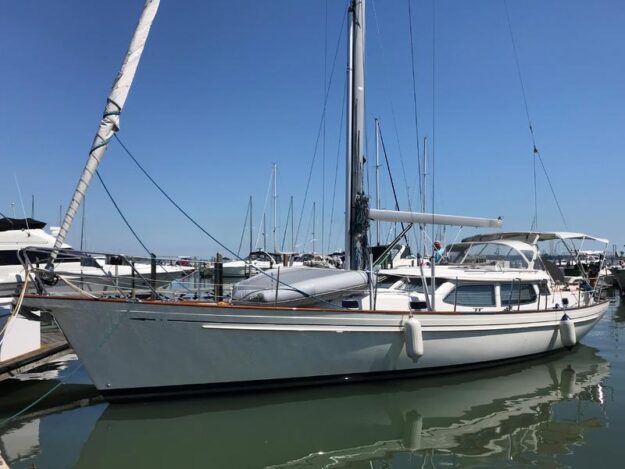 Fantasi 44 Pilot House 2003 sailboat docked in marina under clear blue sky.