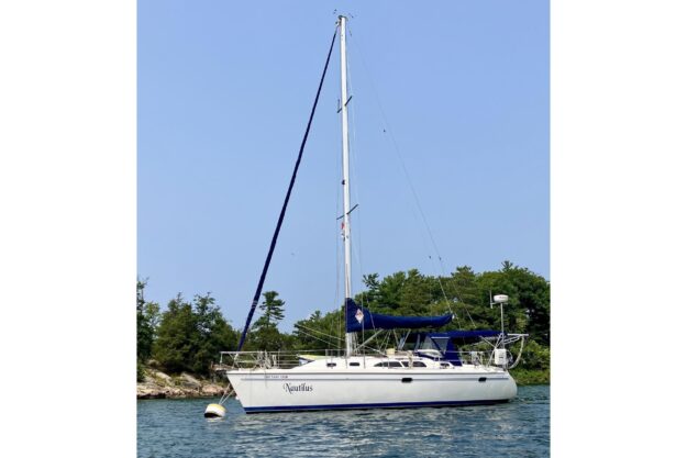 2004 Catalina 350 sailboat anchored on calm water.