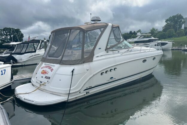 2005 Chaparral Signature 350 boat docked in a marina under cloudy skies.