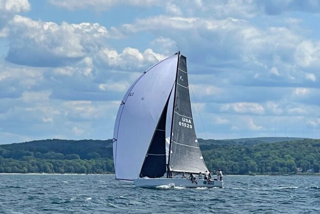 Sailboat Farr 11s 2009 on open water with scenic background.