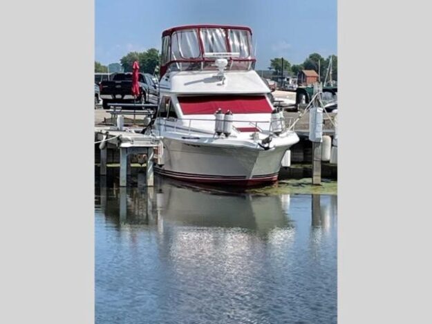 1989 Sea Ray 300 Sedan Bridge docked at a marina.