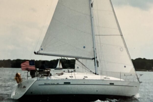 Sailing yacht Beneteau 331, 2001 model, cruising on open water with American flag.