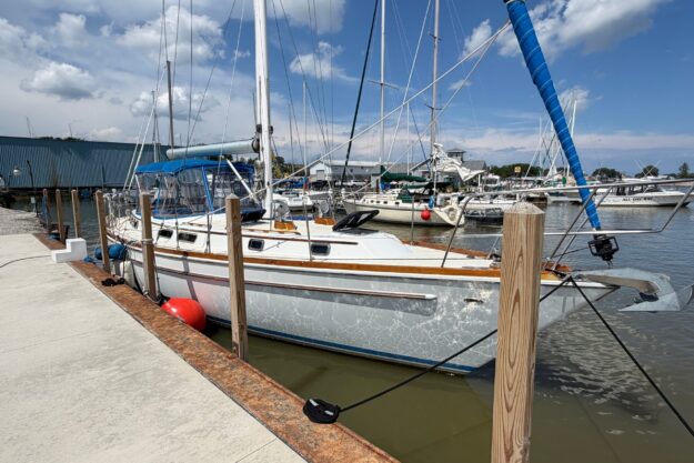 1982 Gulfstar 44 sailboat docked at marina under blue sky.
