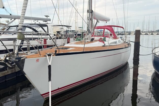 2007 Baltic 52 sailboat docked in marina, featuring sleek design and wooden deck.