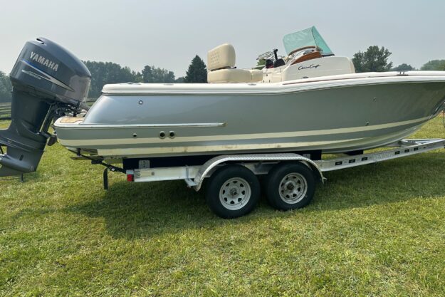 2007 Chris-Craft Catalina 23 boat on trailer with Yamaha engine, parked on grass.