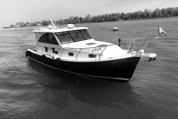 2015 Marlow Pilot 37 boat on calm water, near a shoreline.